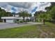 Stately two-story home boasts an attached garage, beautiful landscaping, and a circular driveway at 18620 Wayne Rd, Odessa, FL 33556