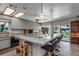 Bright kitchen with white cabinets, breakfast bar, and sliding glass doors leading to the outdoors at 18620 Wayne Rd, Odessa, FL 33556