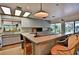 Spacious kitchen with white cabinets, breakfast bar, and sliding glass doors leading to the outdoors at 18620 Wayne Rd, Odessa, FL 33556