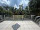 Expansive patio overlooking a beautifully landscaped backyard with mature trees at 18620 Wayne Rd, Odessa, FL 33556