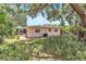 Backyard featuring a partially covered patio and lush landscaping adding to the overall ambiance at 251 Tropic W Blvd, Largo, FL 33770