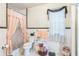 Compact bathroom featuring a toilet, shower with curtain, and window at 251 Tropic W Blvd, Largo, FL 33770