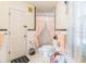 Clean bathroom with a toilet, shower with curtain, and white tiled walls at 251 Tropic W Blvd, Largo, FL 33770