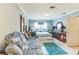 Spacious bedroom with a queen-sized bed, tile flooring, and a comfortable-looking couch at 251 Tropic W Blvd, Largo, FL 33770