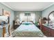Bedroom with comfortable bed, dresser, and charming decor at 251 Tropic W Blvd, Largo, FL 33770