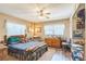 Cozy bedroom featuring a ceiling fan, a wooden bed frame, and a large dresser with decorative items at 251 Tropic W Blvd, Largo, FL 33770