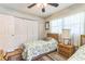 Bright bedroom with two twin beds, a ceiling fan, and plenty of natural light from the windows at 251 Tropic W Blvd, Largo, FL 33770