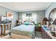 Bright bedroom with comfortable bed, dresser, and charming decor at 251 Tropic W Blvd, Largo, FL 33770