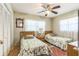 Bright bedroom with two twin beds, a ceiling fan, and plenty of natural light from the windows at 251 Tropic W Blvd, Largo, FL 33770