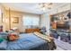 Warm bedroom featuring a ceiling fan, a wooden bed frame, and a large dresser with a TV at 251 Tropic W Blvd, Largo, FL 33770