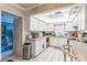 Spacious kitchen features white cabinetry and view into adjacent living area at 251 Tropic W Blvd, Largo, FL 33770