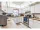 Well-lit kitchen features white cabinetry, a stainless steel stove and neutral countertops and tiled floor at 251 Tropic W Blvd, Largo, FL 33770
