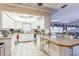 Bright kitchen with tiled floor, breakfast bar, and easy access to living area at 251 Tropic W Blvd, Largo, FL 33770