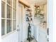 Functional laundry room with washer, storage shelves, cleaning supplies, and exterior door at 251 Tropic W Blvd, Largo, FL 33770
