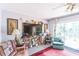 Cozy living room featuring comfortable armchairs, a large flat screen TV, and natural light at 251 Tropic W Blvd, Largo, FL 33770