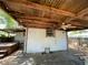 Back patio with hot tub and corrugated metal roof, offering an outdoor entertainment space at 432 2Nd Ne Ave, Largo, FL 33770