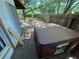 An outdoor hot tub sits on the wood back deck of this home with a backyard with a partial fence at 432 2Nd Ne Ave, Largo, FL 33770