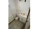 Bathroom featuring a toilet, sink with vanity, and tile flooring ready for renovation at 432 2Nd Ne Ave, Largo, FL 33770