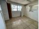 Bedroom with tile flooring, a built-in closet, and a window that offers natural light at 432 2Nd Ne Ave, Largo, FL 33770