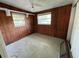 Cozy bedroom with wood paneled walls and natural light from two windows, great potential at 432 2Nd Ne Ave, Largo, FL 33770