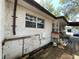 Side view of the home, showcasing the brick exterior, windows, and partial deck at 432 2Nd Ne Ave, Largo, FL 33770