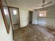 A main bedroom with a ceiling fan and two doorways and peeling wall paint at 432 2Nd Ne Ave, Largo, FL 33770
