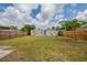 Spacious backyard with a wood fence and green grass surrounding the house at 1020 58Th N Ave, St Petersburg, FL 33703