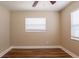 Well-lit bedroom with hardwood floors, neutral paint, and a large window for natural light at 1020 58Th N Ave, St Petersburg, FL 33703
