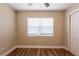 Bedroom with wood-look flooring, closet, and natural light from the window at 1020 58Th N Ave, St Petersburg, FL 33703