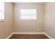 Cozy bedroom showcasing wood flooring, neutral paint, and a bright window with white blinds at 1020 58Th N Ave, St Petersburg, FL 33703