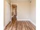 Bright bonus room featuring an adjacent room, wood flooring, closet storage, and neutral paint at 1020 58Th N Ave, St Petersburg, FL 33703
