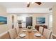 A bright dining room adjacent to the kitchen features wood floors and seating for six at 1020 58Th N Ave, St Petersburg, FL 33703
