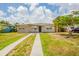 Charming single story home featuring a well-maintained lawn and long driveway at 1020 58Th N Ave, St Petersburg, FL 33703