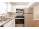 Well-lit kitchen features stainless steel appliances and granite countertops at 1020 58Th N Ave, St Petersburg, FL 33703