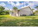 Spacious backyard with lush lawn and enclosed patio with great natural light perfect for relaxing and entertaining at 2015 Gardenia Landings Ln, Sun City Center, FL 33573