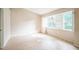 Inviting bedroom featuring light wood floors, bright window with plantation shutters, and a neutral color palette at 2015 Gardenia Landings Ln, Sun City Center, FL 33573