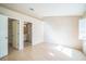 Spacious bedroom with wood floors, natural light from a large window, and convenient access to the en-suite bathroom at 2015 Gardenia Landings Ln, Sun City Center, FL 33573