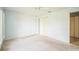 Bedroom with carpet flooring, a ceiling fan, and a sliding door closet near the bathroom at 2015 Gardenia Landings Ln, Sun City Center, FL 33573