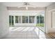 Bright and airy enclosed patio with tile flooring, multiple windows, and ample natural light with beautiful outdoor view at 2015 Gardenia Landings Ln, Sun City Center, FL 33573