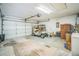A spacious two-car garage featuring a golf cart, an automatic garage door and concrete flooring at 2015 Gardenia Landings Ln, Sun City Center, FL 33573