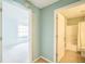 Hallway with doors to bedroom and bathroom showing neutral color palette at 2015 Gardenia Landings Ln, Sun City Center, FL 33573