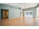 Living room showing multiple doorways, hardwood floors, and a ceiling fan at 2015 Gardenia Landings Ln, Sun City Center, FL 33573