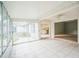 Bright sun room featuring tile floors and sliding glass doors with views into the kitchen and living room at 2015 Gardenia Landings Ln, Sun City Center, FL 33573