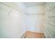 Walk-in closet with wood floor and multiple shelves for ample storage at 2015 Gardenia Landings Ln, Sun City Center, FL 33573