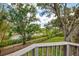 Waterfront property with fenced yard, mature trees, and serene canal views at 2504 Tanglewood Dr, Sarasota, FL 34239