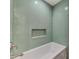Stylish bathroom featuring decorative tile, built-in shelf, and modern fixtures at 2504 Tanglewood Dr, Sarasota, FL 34239