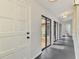 Inviting hallway with sleek tile flooring and courtyard views, creating a bright and airy atmosphere at 2504 Tanglewood Dr, Sarasota, FL 34239