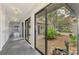 Hallway view of a private courtyard with lush greenery, offering a serene and bright atmosphere at 2504 Tanglewood Dr, Sarasota, FL 34239
