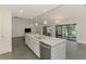Kitchen with island featuring granite countertops, stainless steel appliances, and an open-concept living space at 2504 Tanglewood Dr, Sarasota, FL 34239