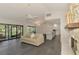 Open-concept living room and kitchen area with a stone fireplace and access to a screened patio at 2504 Tanglewood Dr, Sarasota, FL 34239